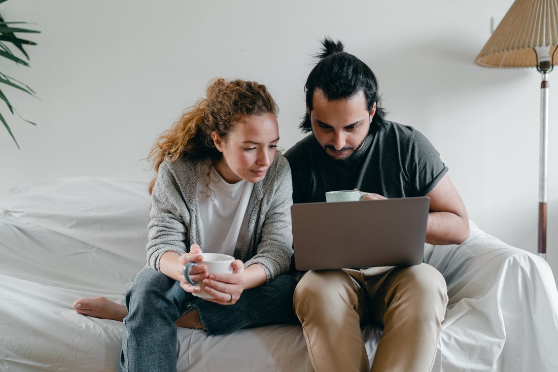 Couple browsing laptop