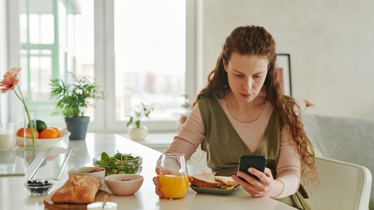 Woman texting breakfast